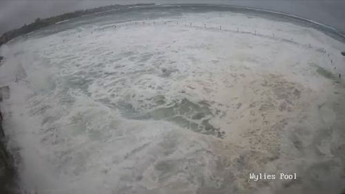 The Wylie's baths at coogee is completely underwater as huge swells smash the shoreline 