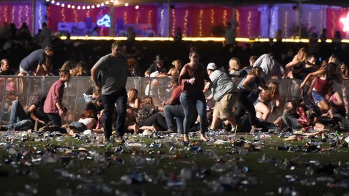 Festivalgoers are seen running from the event at the Mandalay Bay Resort and Casino. (Getty Images)