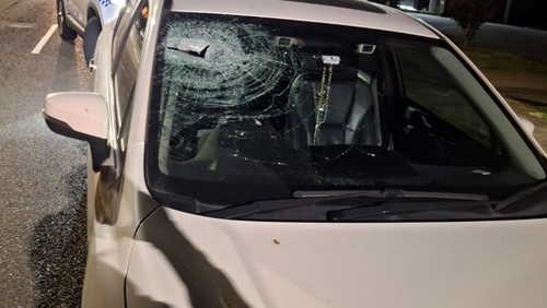 A car with damage to the windscreen from a rock.
