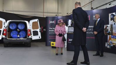 Britain's Queen Elizabeth II, Prince William and Chief Executive Gary Aitkenhead, right, view a demonstration of a Forensic Explosives Investigation, with a model explosive device in a vehicle, during a visit visit the Defence Science and Technology Laboratory (DSTL) at Porton Down, England, Thursday Oct. 15, 2020, to view the Energetics Enclosure and display of weaponry and tactics used in counter intelligence