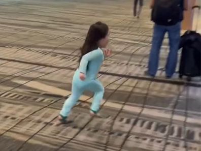 Toddler running through airport.