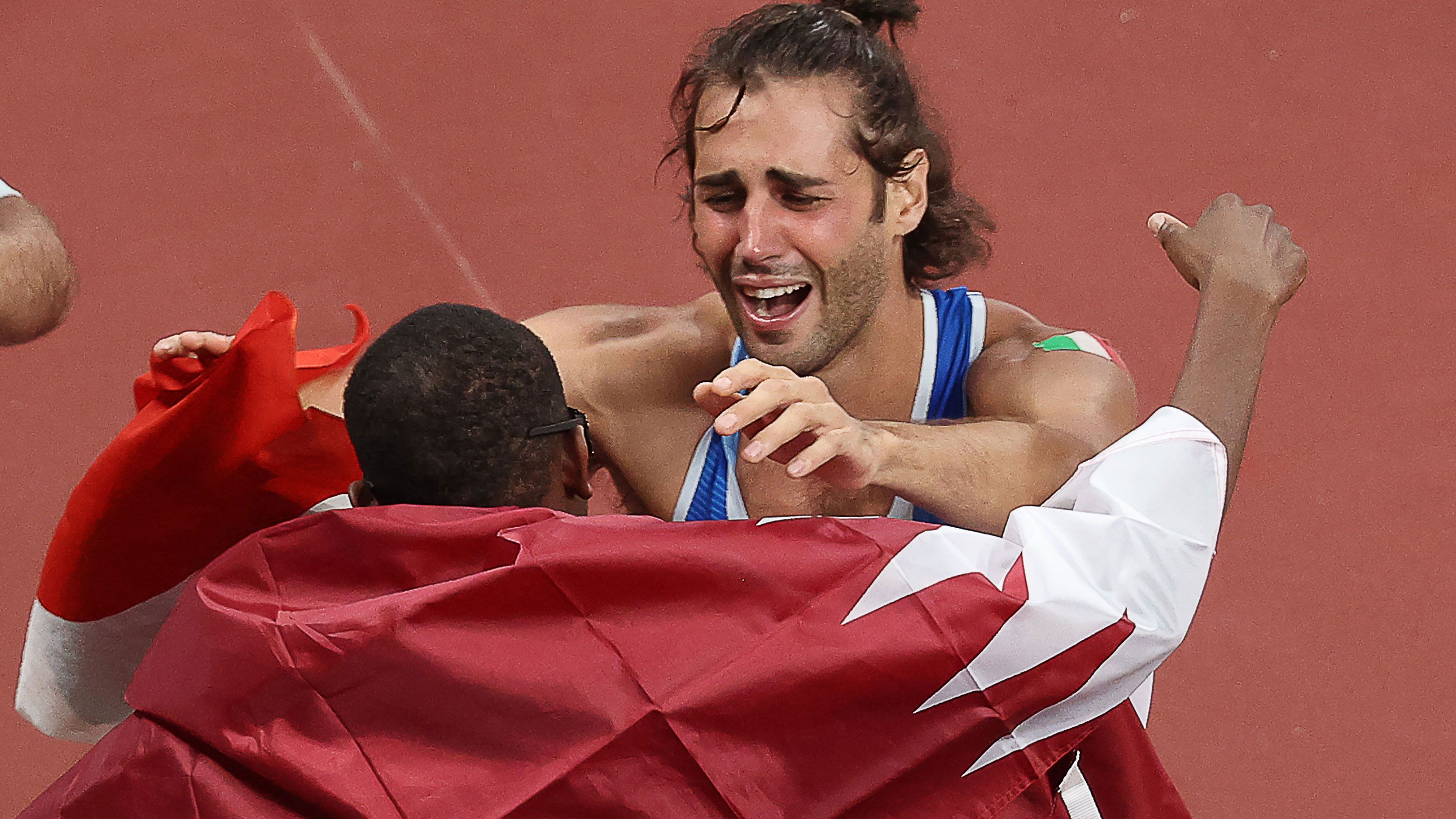 Mutaz Essa Barshim of Qatar and Italy&#x27;s Gianmarco Tamberi embrace after deciding to share gold.