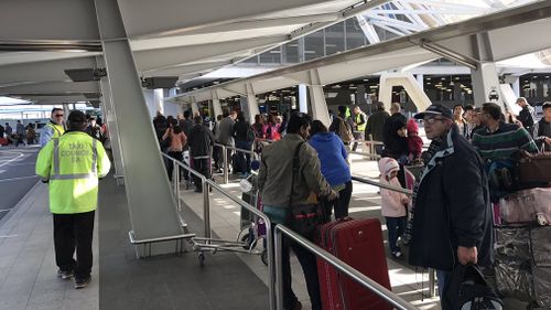 Queues of people have banked up at the airport as the taxi strike takes off. (9NEWS)
