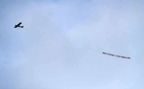 LEEDS, ENGLAND - JANUARY 22: A plane flies over the stadium with a message directed to UK Prime Minister Boris Johnson during the Premier League match between Leeds United and Newcastle United at Elland Road on January 22, 2022 in Leeds, England. (Photo by George Wood/Getty Images)
