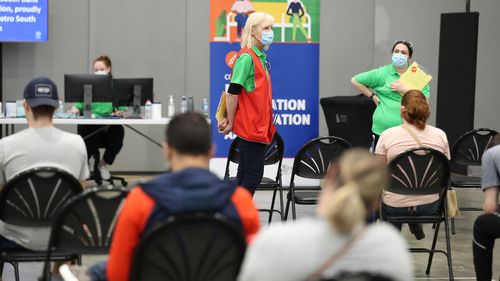 Staff work at a vaccination hub at Brisbane Convention & Exhibition Centre.