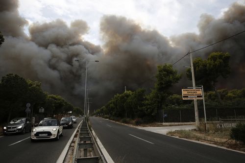 Thick clouds of smoke are seen blanketing parts of Athens. Picture: AAP