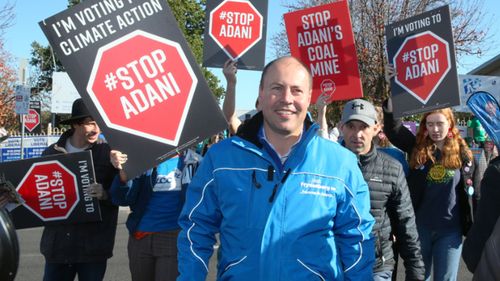 Josh Frydenberg trailed by Adani mine protesters on election day.