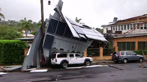 Cars are stuck beneath the roof until it can be safely removed. (9NEWS)