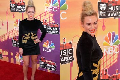 Hilary Duff brings Tinseltown-chic to the red carpet with a top knot and a bold orange lip.