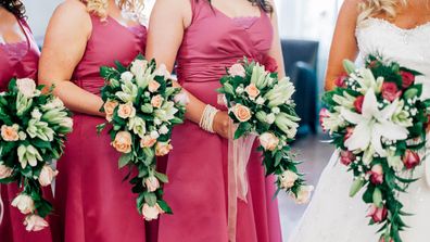 Bridesmaid standing with bride