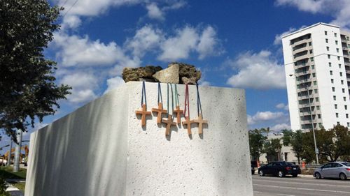 Six wooden crosses represent the victims of the Florida bridge disaster. (Photo: AP).