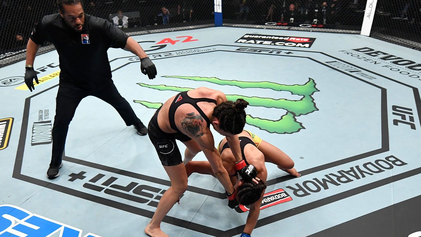 (L-R) Marina Rodriguez of Brazil punches Amanda Ribas of Brazil in a strawweight fight during the UFC 257 event 