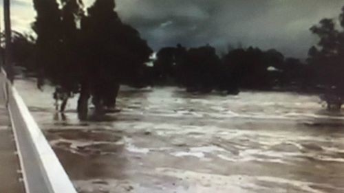 The swollen Todd River in Alice Springs, where a man went missing in floodwaters. (9NEWS)