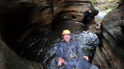 Jumping backwards into a pool of water in Empress Falls canyon