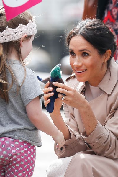 Meghan chats with a young girl in Auckland, New Zealand. 