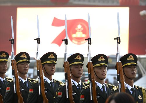 Members of a Chinese military honour guard stand at attention during a rehearsal before a large parade to commemorate the 70th anniversary of the founding of Communist China in Beijing.