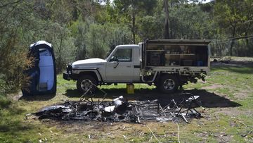 Tendered photos of Russell Hill and Carol Clay&#x27;s burnt-out campsite were shown to the jury.