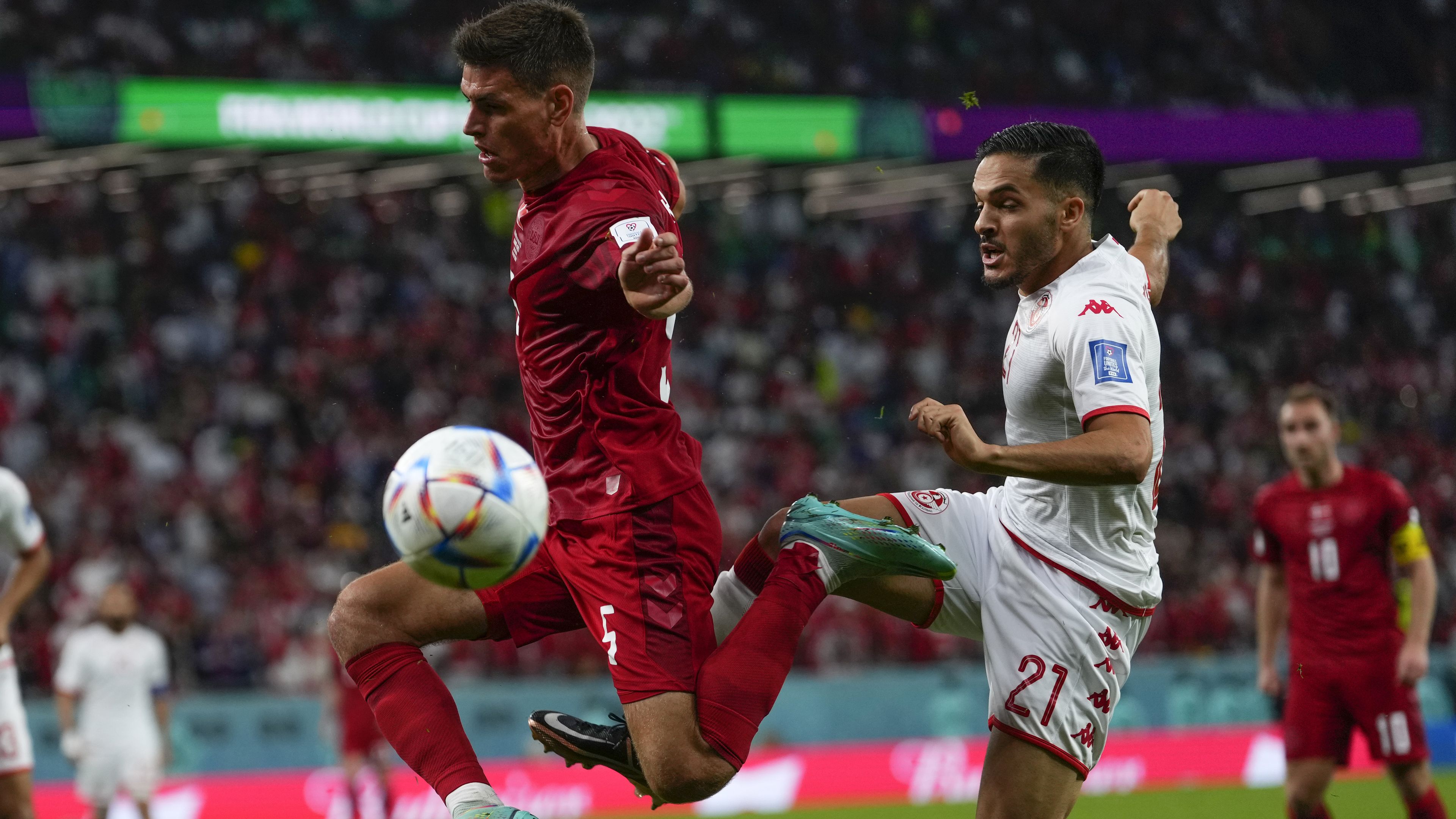 Denmark&#x27;s Joakim Maehle, left, vies for the ball with Tunisia&#x27;s Wajdi Kechrida during the World Cup group D soccer match between Denmark and Tunisia, at the Education City Stadium in Al Rayyan, Qatar, Tuesday, Nov. 22, 2022 