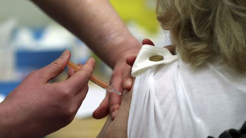 Mary Williams, right, receives an injection of the Oxford/AstraZeneca vaccine at the mass vaccination centre in Newcastle Upon Tyne, England on January 11, 2021