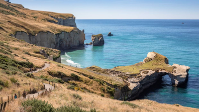 Tunnel Beach is a must-visit hidden marvel where a short track and tunnel opens up to a secluded beach.