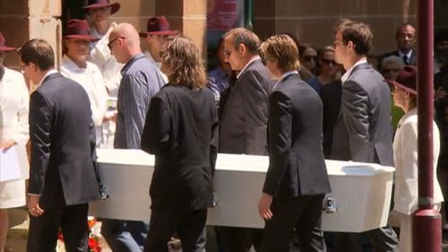 Tori Johnson's father Ken and partner Thomas Zinn are among the people carrying Mr Johnson's coffin into the church. (9NEWS)