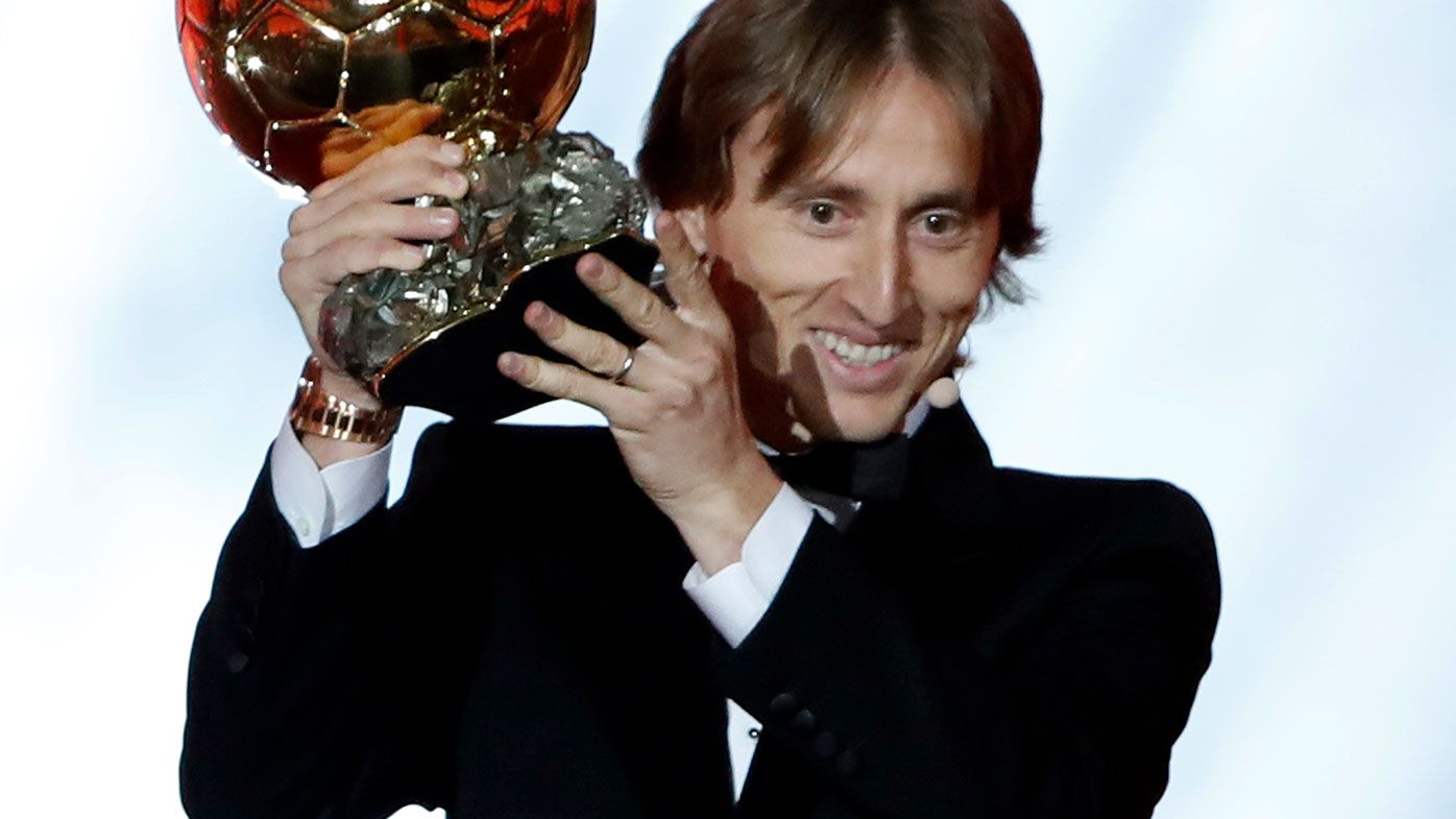 Real Madrid's Luka Modric celebrates with the Ballon d'Or award.