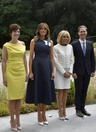 Melania Trump joined by the spouses of other NATO leaders donned&nbsp; a navy sleeveless dress with a flared skirt by Calvin Klein in Brussels, July 2018