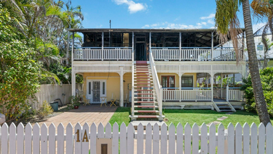 Buyers haggle over Brisbane's half-burnt house as it gets passed in at auction. Negotiations are underway to close the deal.