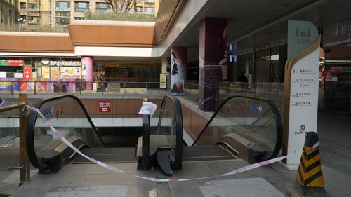 Escalators are blocked off at a partially shuttered Evergrande commercial complex in Beijing
