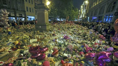 People pay their respects for the victims of the Manchester bombing during a vigil at 10.31pm in St Ann's Square in Manchester, Britain, 29 May 2017. (AAP)