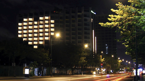 In this Apr. 22, 2020 photo, rooms at Ibis Styles hotel in Vung Tau, Vietnam, are lit up, forming a heart shape to support the country unity in the fight against COVID-19. 