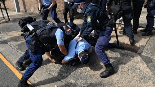 Police arrest protestors at Victoria Park in Sydney.