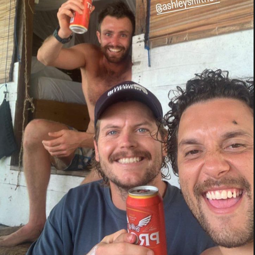 Elliot Foote enjoying a bear with two friends to celebrate his survival after disappearing in the Indonesian ocean.