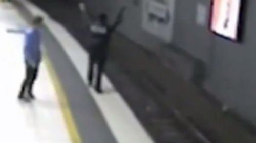 Mr Andrews could be seen waving his arms to flag down the train driver. (9NEWS)