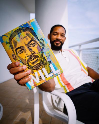 Will Smith holding his  new memoir Will