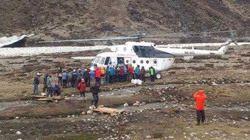 Mountaineers and Nepalese Sherpa guides evacuated from Everest Base Camp wait to board a rescue chopper to be flown to Lukla, in Pheriche, Nepal. (AP)