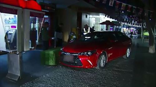 The car narrowly missed a family sitting outside a cafe. (9News)