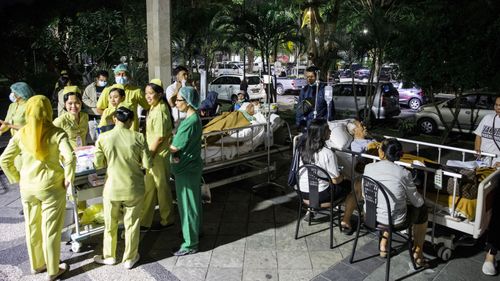 Hospital patients are moved outside of the hospital building after an earthquake was felt in Denpasar, Bali, 