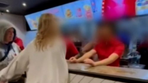 Shocking footage has emerged of a young woman lashing out and spitting at McDonalds staff in Adelaide.Police are now investigating the incident, which the Retail Workers' Union has labelled "vile and disgusting."
