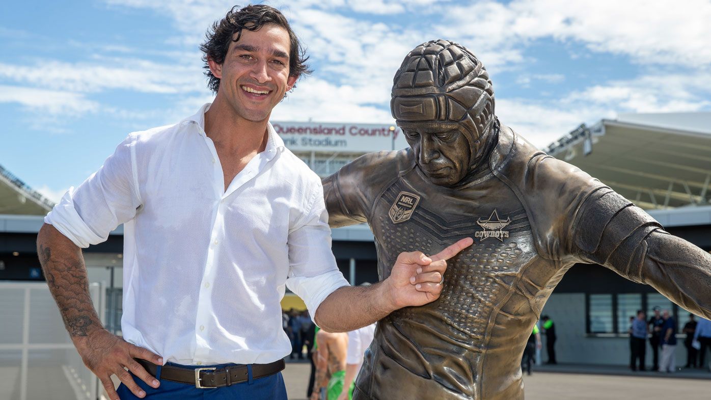 Former NRL Player Johnathan Thurston poses for a photograph next to his statue at Queensland Country Bank Stadium in Townsville