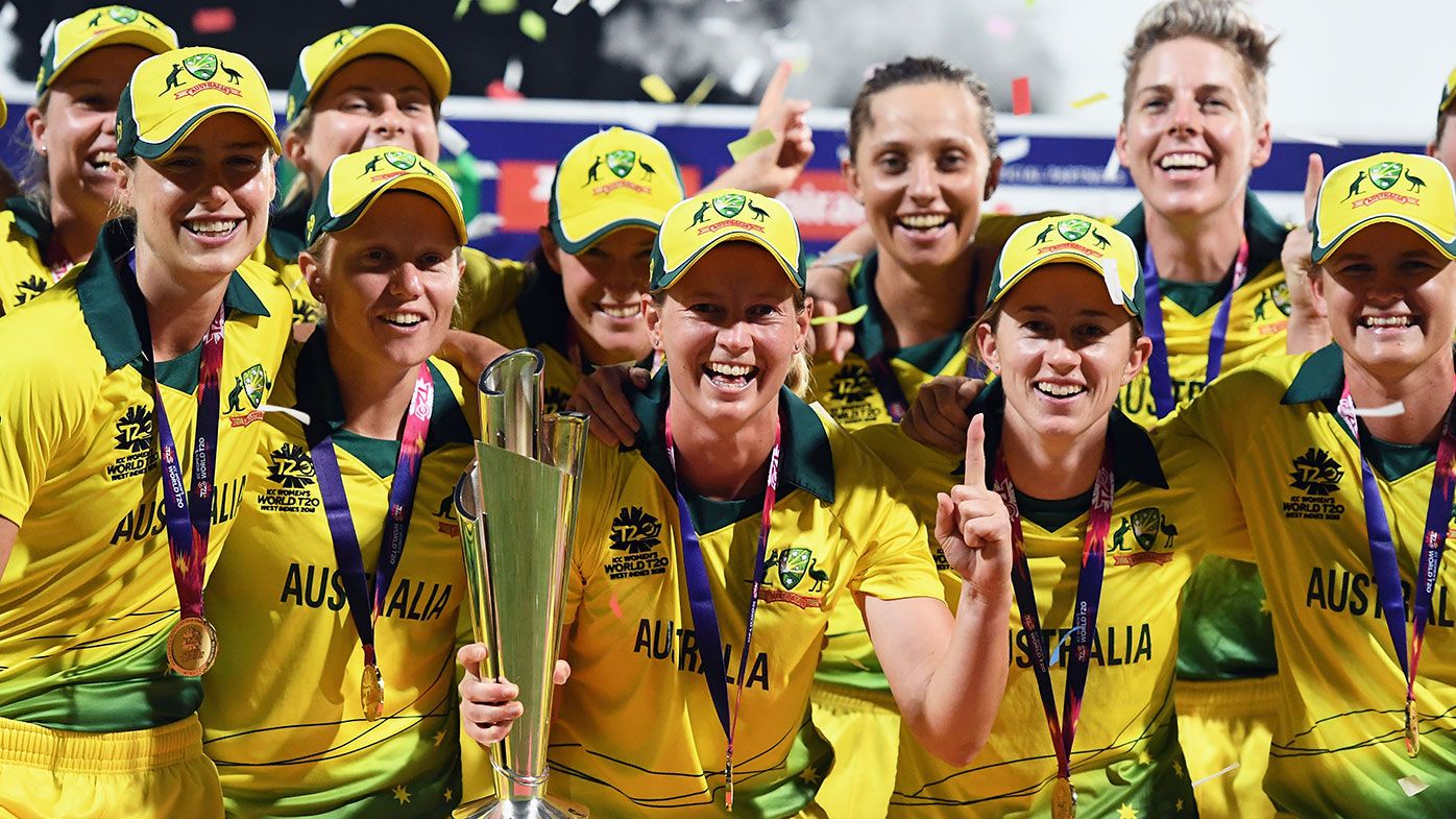 Australia celebrates with the World T20 trophy after beating England in the final.
