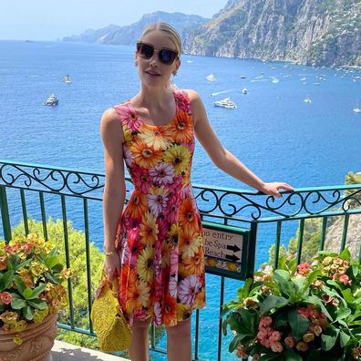 Lady Kitty Spencer poses in Positano in a bright flower patterned dress.