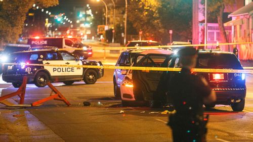 Police investigate the scene where a car crashed into a roadblock in Edmonton Alta. (AP)