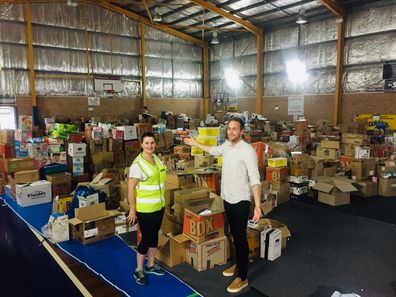 Tim Davies and Michelle Babington Ulladulla Civic Centre Manager at the Milton showground basketball court, which is chock-full of donations 