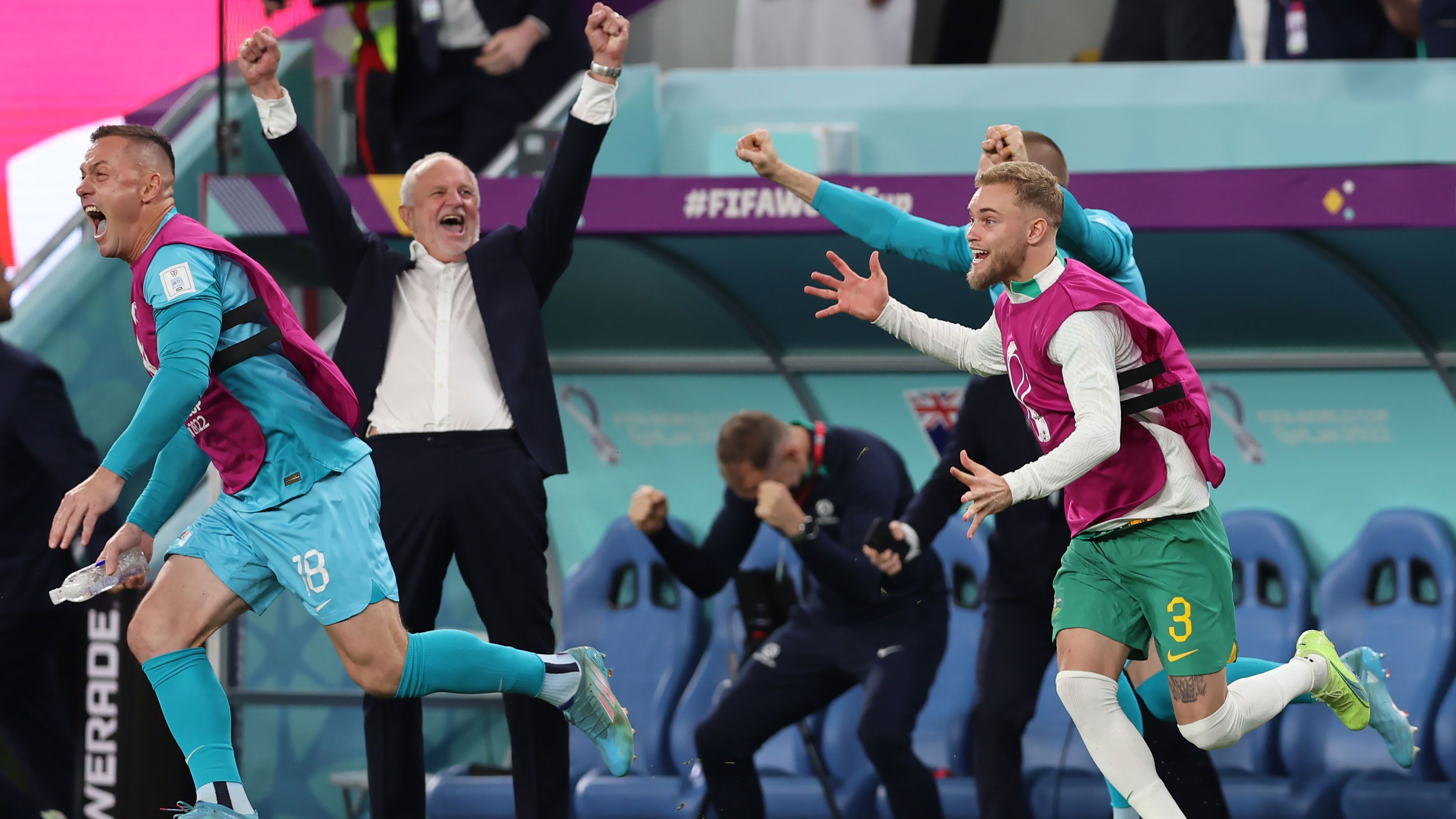 Danny Vukovic, Nathaniel Atkinson and Andrew Redmayne celebrate along with Graham Arnold as the full-time whistle blows on the Socceroos&#x27; win over Denmark.