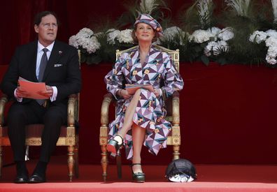 Belgium's Princess Delphine and her husband James O'Hare watch the National Day Parade from the podium in front of the Royal Palace in Brussels, Wednesday, July 21, 2021. Belgium celebrates its National Day on Wednesday in a scaled down version due to coronavirus, COVID-19 measures. (AP Photo/Olivier Matthys)