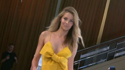 Myer ambassador Jennifer Hawkins struts in mustard Alex Perry dress. (9NEWS)