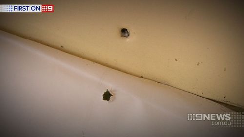 Some bullets pierced the front of the building and continued into interior walls. (9NEWS)