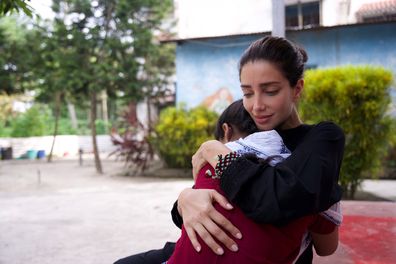 Jessica Kahawaty hugs a girl who was rescued from child sex trafficking.