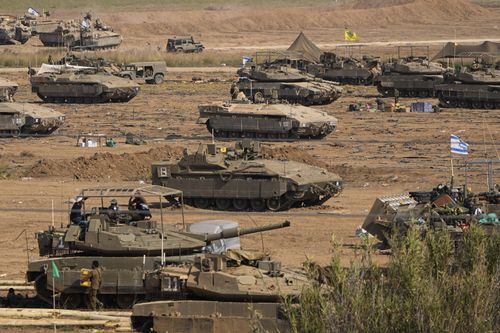 Israeli soldiers gather in a staging area near the border with Gaza Strip, in southern Israel, Tuesday, Oct. 24, 2023.